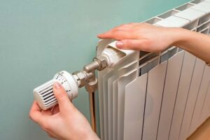 thermostatic radiator valve (TRV) showing ideal energy-saving settings in a modern UK home
