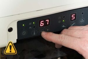 A homeowner checking the boiler control panel because the boiler timer is not working properly.