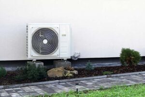 Modern air source heat pump installed outside a UK home